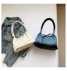 Flat lay of cream and denim contrast bow tote bags with minimalist retro style details