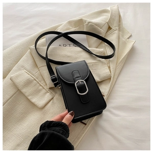 Detailed view of black matte PU leather mobile phone bag with silver metal buckle on a blazer