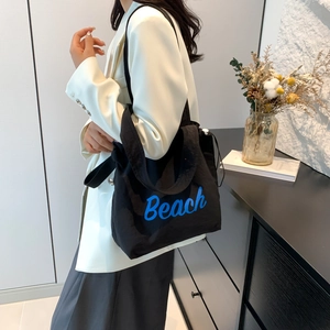 Lightweight black drawstring tote bag with blue Beach print and adjustable strap