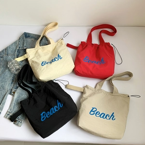 Multi-color lightweight nylon tote bag with Beach print and drawstring closure
