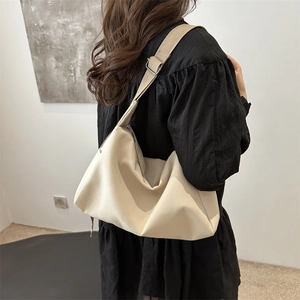 Minimalist beige nylon large capacity crossbody bag with adjustable wide strap and solid color