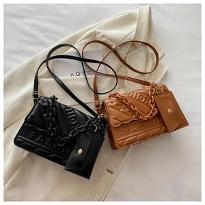 Detailed close-up of quilted PU leather crossbody bags with embossed fashion lettering
