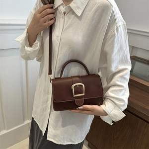 Petit sac carré minimaliste en cuir marron foncé avec boucle dorée et bandoulière chic