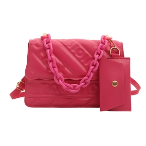 Quilted rose pink crossbody bag with thick chain handle and embossed fashion lettering
