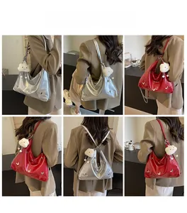 Detailed views of silver and red tote bags featuring butterfly charms and plush pendants