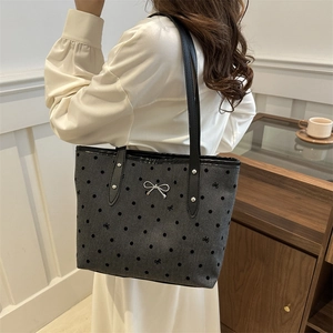 Chic dark grey polka dot tote bag with silver bow accent and black leather straps