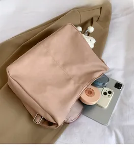 Detail view of the spacious inner compartment and lychee texture of the beige tote bag