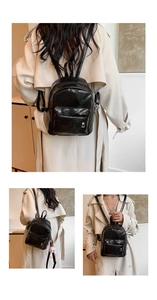 Detail view of the sleek black glossy mini backpack with adjustable thin straps