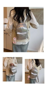Detailed views of a mini silver metallic backpack with pink plush charm and slim straps