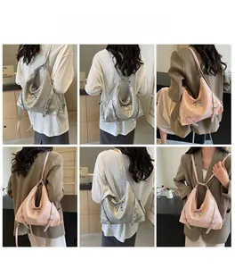 Dettaglio della borsa tote metallizzata con chiusura a fiocco e fibbia laterale chic