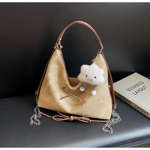 Dettaglio borsa tote vintage kaki con lacci incrociati e ciondolo a nuvola