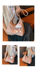 Pink crescent shoulder bag detail with cute cloud plush charm and wide strap