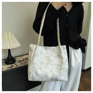 Detail of white butterfly print tote bag with stylish woven leather shoulder strap