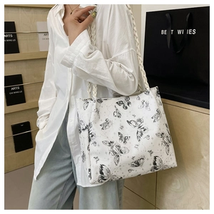 Detail of white butterfly print tote bag featuring stylish woven rope handles and large capacity