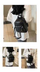 Detailansicht des schwarzen Stepprucksacks aus PU-Leder mit weißem Pompon-Anhänger
