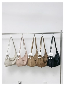Row of crescent tote bags in five colors with cute cloud pendants on metal hangers