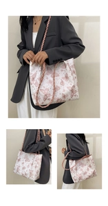 Detail of large white tote bag with pink butterfly print and woven leather straps
