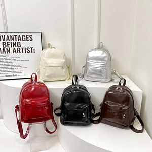 Sleek PU leather mini backpacks in five trendy colors displayed on white pedestals