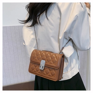 Brown quilted crossbody bag featuring a silver twist lock and metal chain strap details