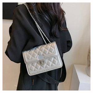 Silver quilted chain bag shown on shoulder over a black blazer for a stylish look
