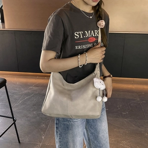 Minimalist beige large capacity tote bag with flower detail and cloud charm on model
