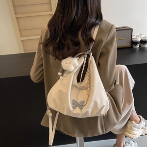 Casual beige butterfly tote bag with chain strap shown on model for daily commuting