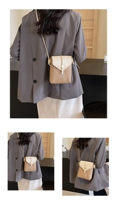 Close-up of contrast color crossbody phone bag with litchi texture and metal snap button