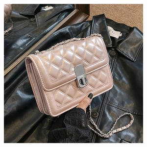 Detail view of pink quilted chain bag with silver twist lock and premium PU leather finish