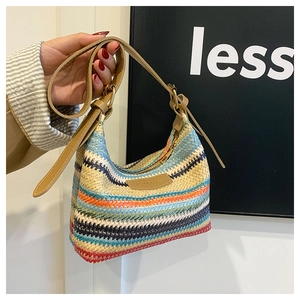 Detail of colorful woven wave pattern and premium brown leather strap on hobo bag