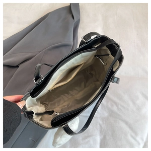 Top view of large black leather tote bag showing spacious interior and zipper pocket