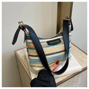 Detail of multi-color woven straw bag with fashion leather tag and gold metal buckle