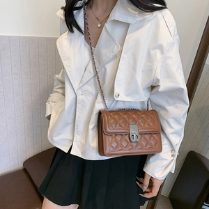 Women's brown quilted chain strap crossbody bag with classic metal buckle and leather strap