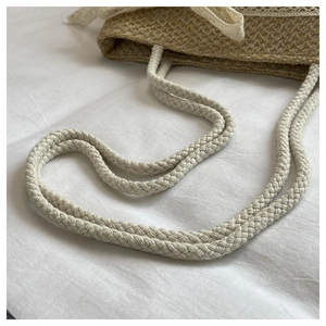 Detailed macro view of woven straw texture with white lace border and bow decoration