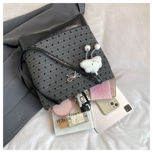 Interior view of large canvas tote bag showing storage of phone, tablet and umbrella