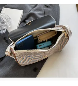 Detail showing the spacious interior of the embroidered crossbody bag for daily essentials