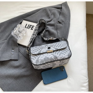 Close-up of vintage texture wave pattern crossbody bag with wide shoulder strap