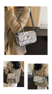Detail of artistic oriental cloud pattern on a retro shoulder bag with a wide strap