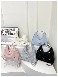 Large butterfly tote bags displayed in five metallic colors with elegant chain straps