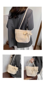 Detail showing delicate lace trim and large beige bow on a straw tote beach bag