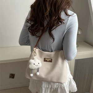 Chic cream waffle fabric tote bag with brown leather strap and cloud charm detail