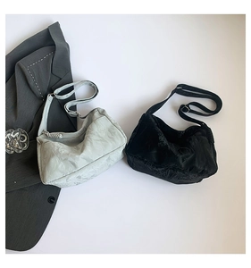 Flat lay of pleated hobo shoulder bags in light grey and black with stylish business blazer
