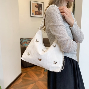 White butterfly tote bag with silver chain strap and pleated leather texture for women