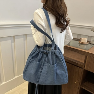Minimalist large capacity denim tote bag with drawstring closure and shoulder straps