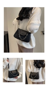Detail view of black leather shoulder bag featuring silver floral chain strap and logo