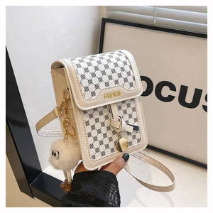 Vue détaillée du mini sac carré crème avec ornements dorés et pendentif en peluche blanc