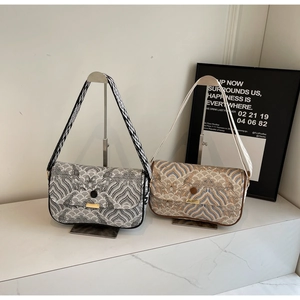 Close-up of retro wave pattern crossbody bags with gold buckles and wide fabric straps