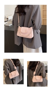 Detail of soft pink crossbody bag featuring a silver heart chain and pebble leather