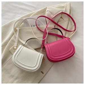 Detailed top view of white and magenta saddle bags on casual blazer fabric texture