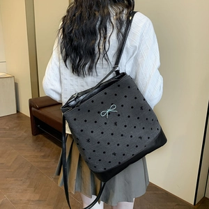 Gray polka dot tote bag with blue bow detail shown on a model for daily commute