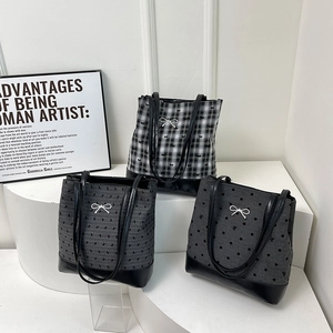 Three large capacity tote bags in polka dot and grid patterns with bow detail